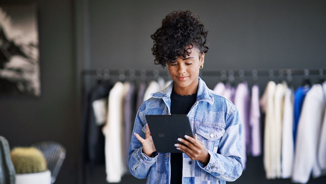 A woman holding a tablet in a retail store