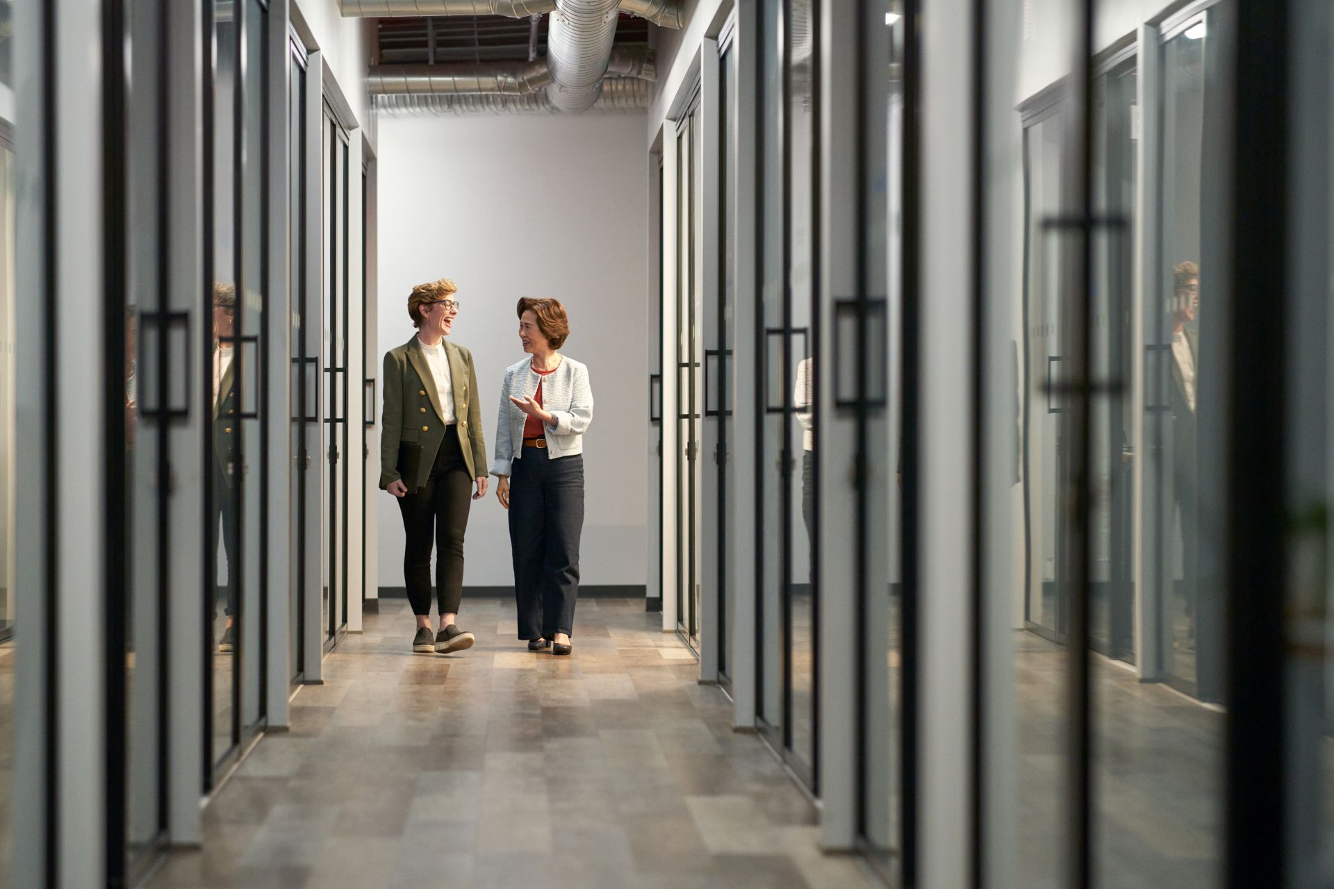 Two professionals collaborating in a modern, technology-enabled workplace