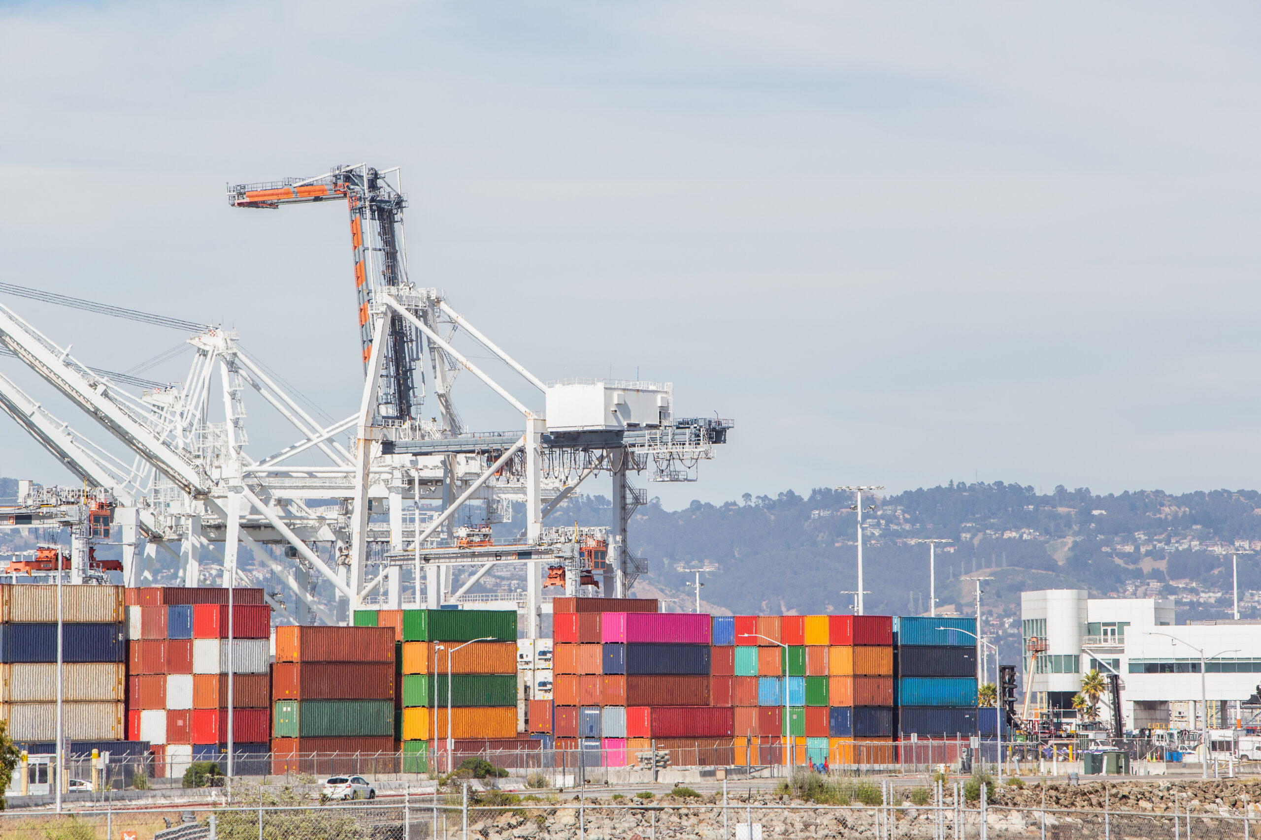 Shipping port featuring cranes and colorful shipping containers