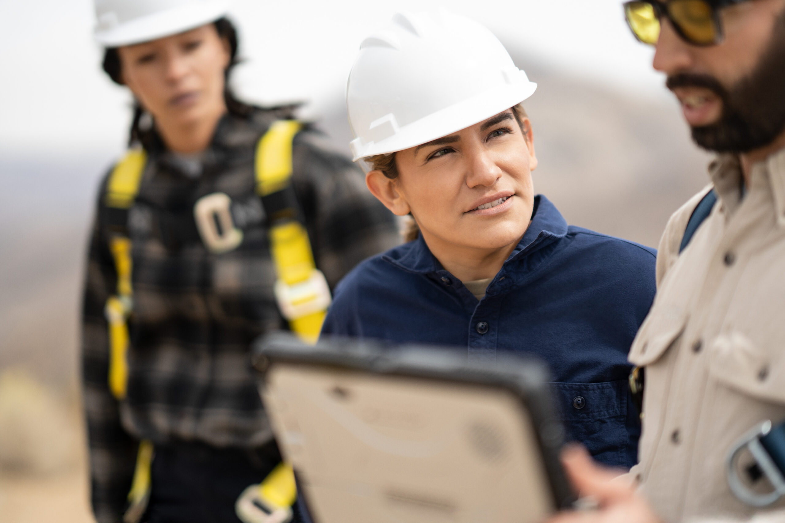 Field engineers discussing data after the inspection of turbines on a wind farm