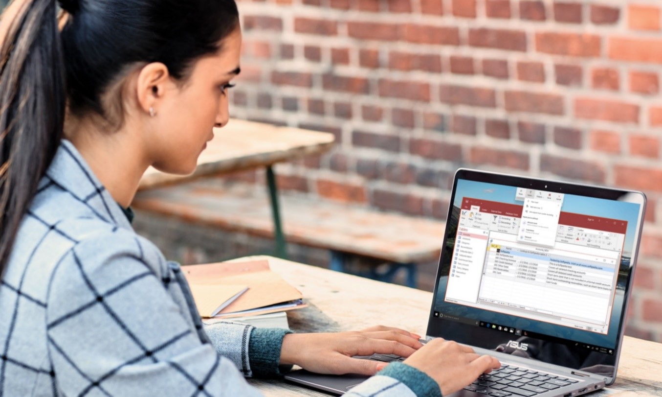 Woman sitting at laptop using Microsoft Power Automate