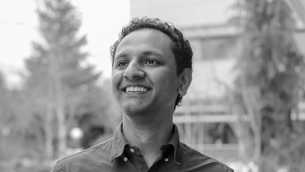 Nikunj Raghuvanshi wearing glasses and smiling at the camera