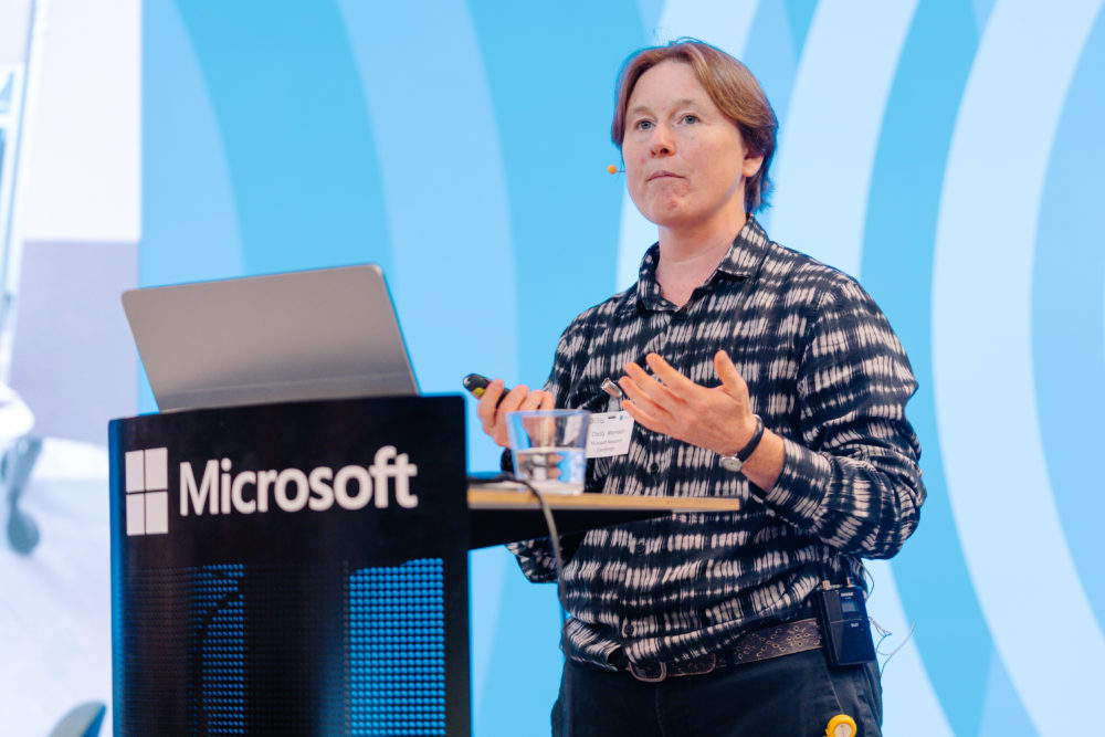 Cecily Morrisson as a podium giving her talk