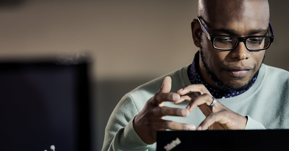Image of a man looking at his laptop