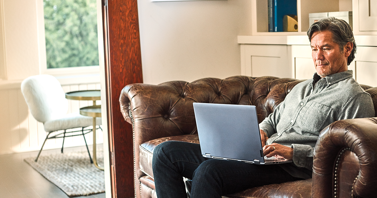 Man interacting with a Leno Yoga laptop