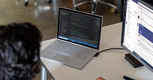 An image of adult male at desk workstation on a Surface Book 3