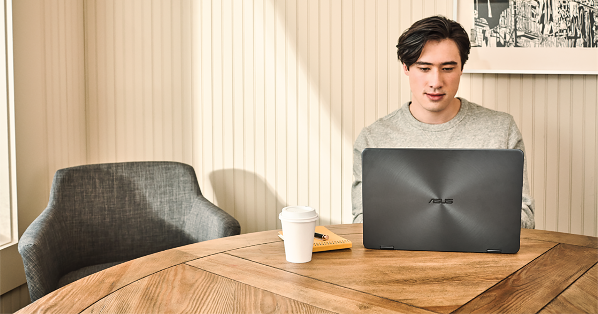 Young man interacting with an Asus Zenbook laptop