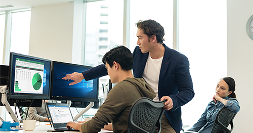 An image of two male and one female worker in open office setting