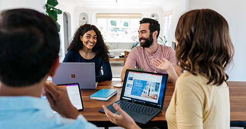 An image of a group of tech workers having a meeting around a table
