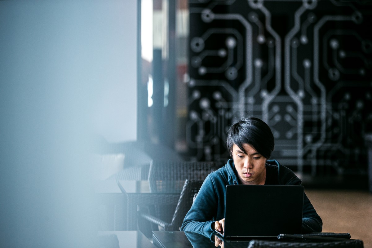 A tech worker with visual impairment uses assistive technology while visiting the Microsoft office