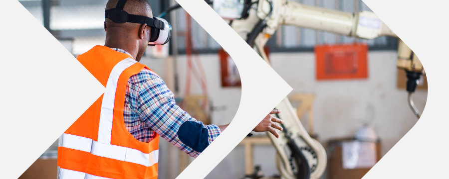 Adult male wearing orange safety vest works in mechanical shop
