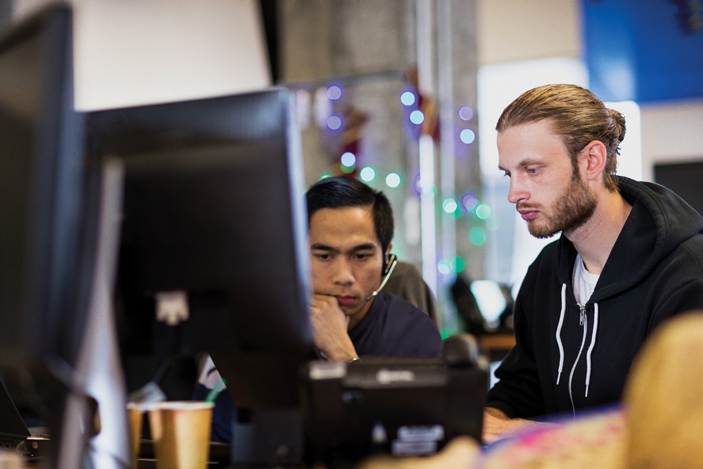 Two adults collaborating at a work station
