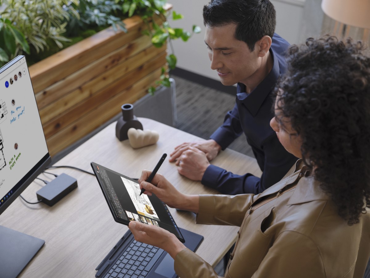 Two adults collaborating while standing at a desk