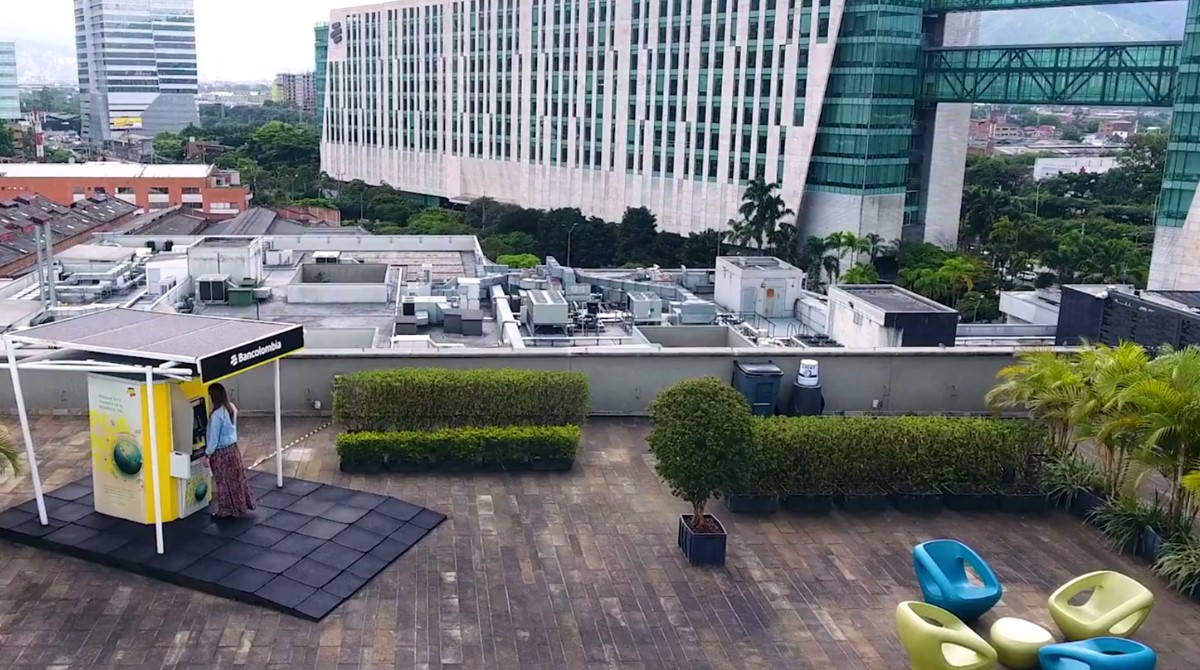 Aerial view of customer using a Bancolumbia ATM