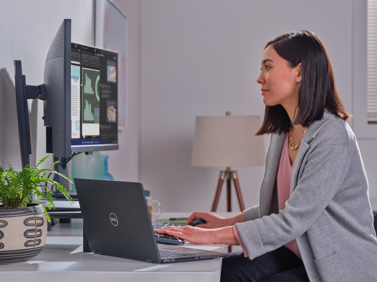 Business person uses Dell 7520 2-in-1 connected to dual monitors at their home office
