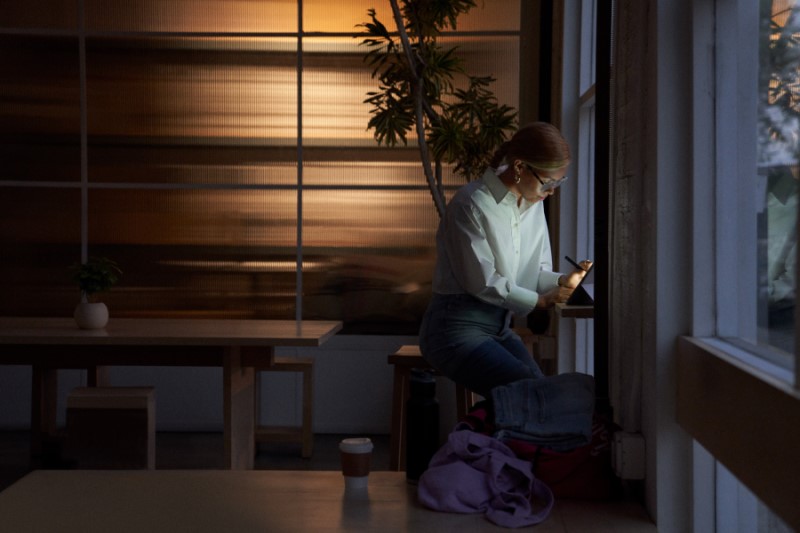 Retail store manager using a tablet while working remote from a cafe