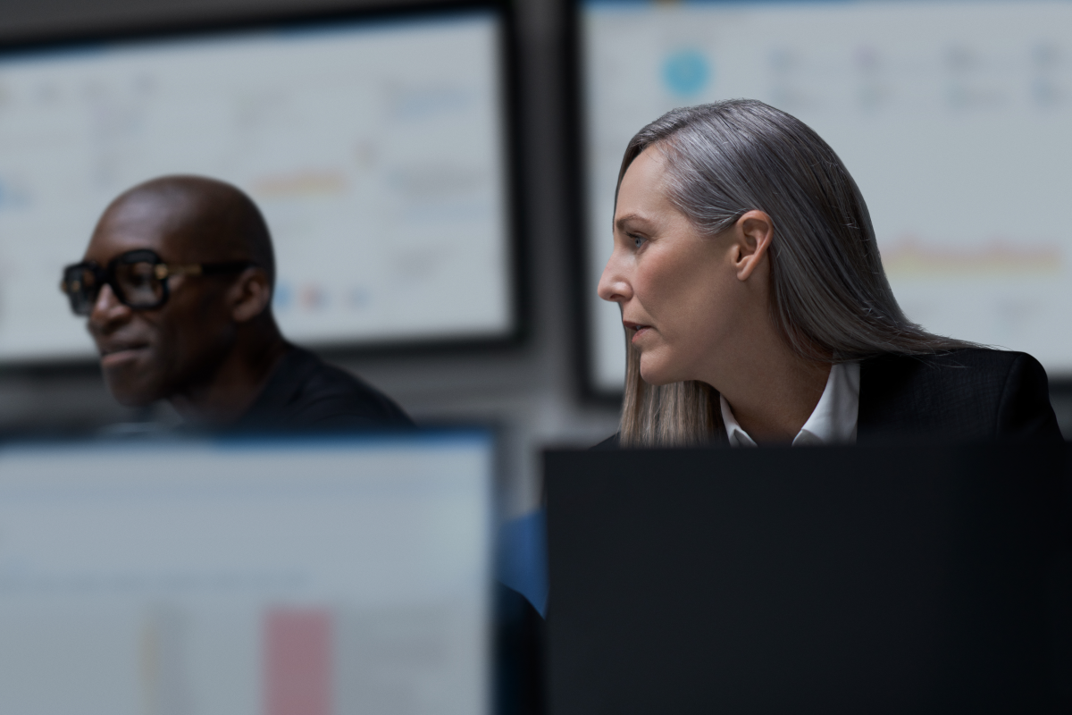 CISO (chief information security officer) collaborating with a practitioner in a security operations center