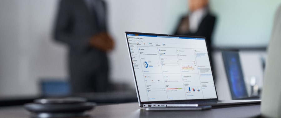 Camera focused on laptop screen showing security dashboard while security decision makers present to the board of executives on security topics