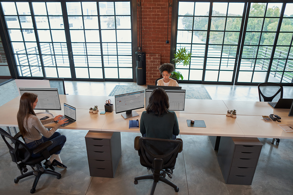 Photo of enterprise office workers in focused work in an open work space