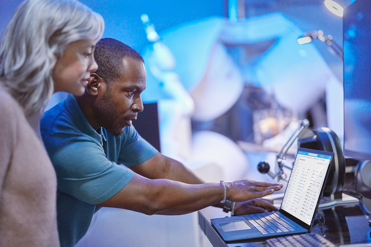 Photo of medical researchers collaborating and using technology to review medical research insights