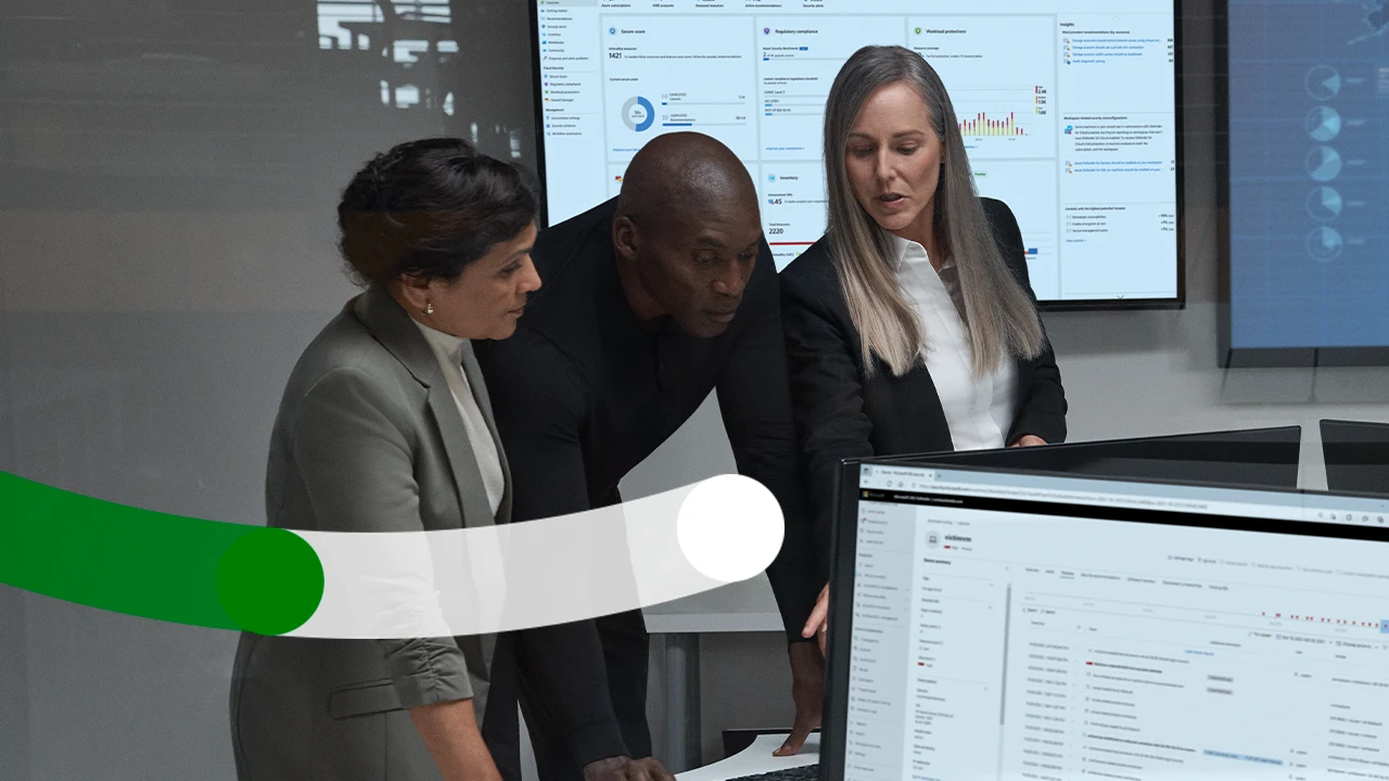 Three business decision makers standing looking at a computer together