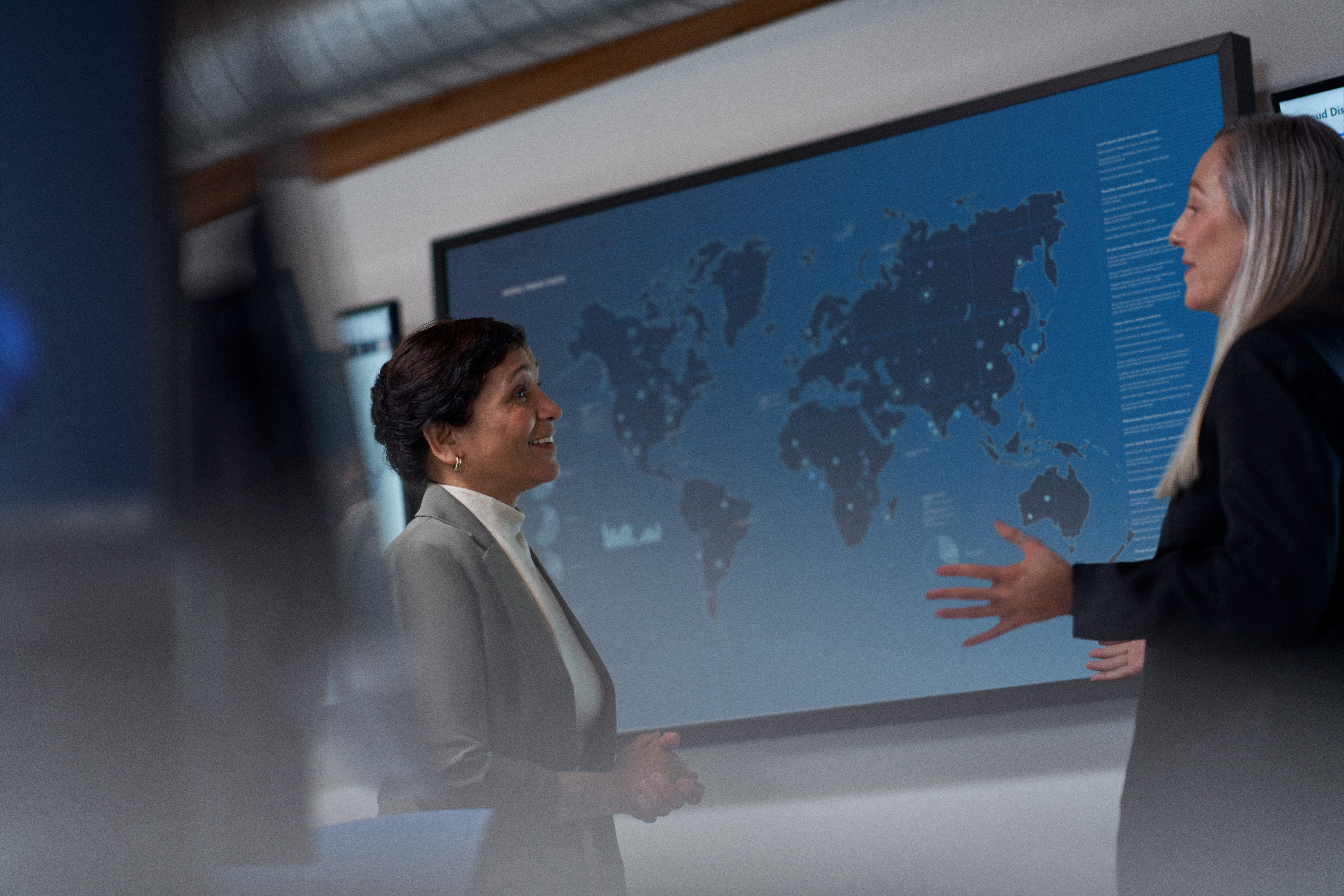 Two security business decision makers chat in a conference room