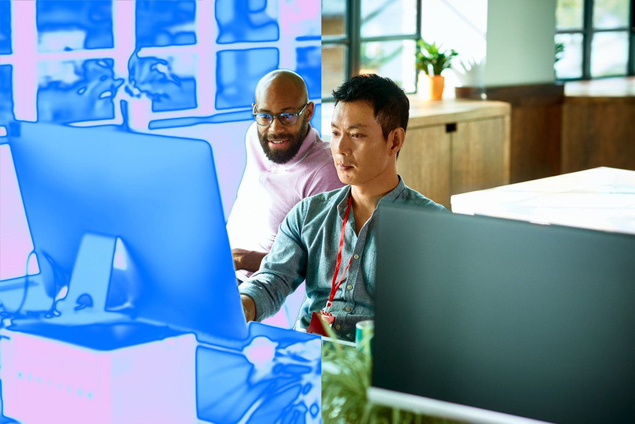 Two men looking at a computer monitor