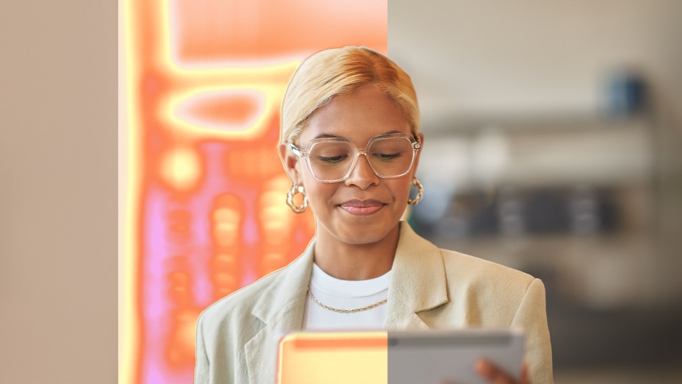 A woman holds a tablet computer