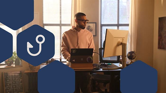 Photo of a developer in home office, with the icon of phishing in overlay