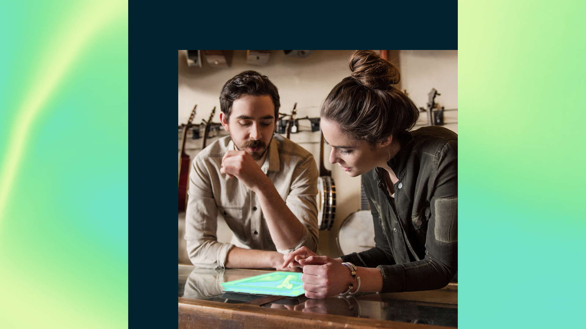 Two people look at a tablet together