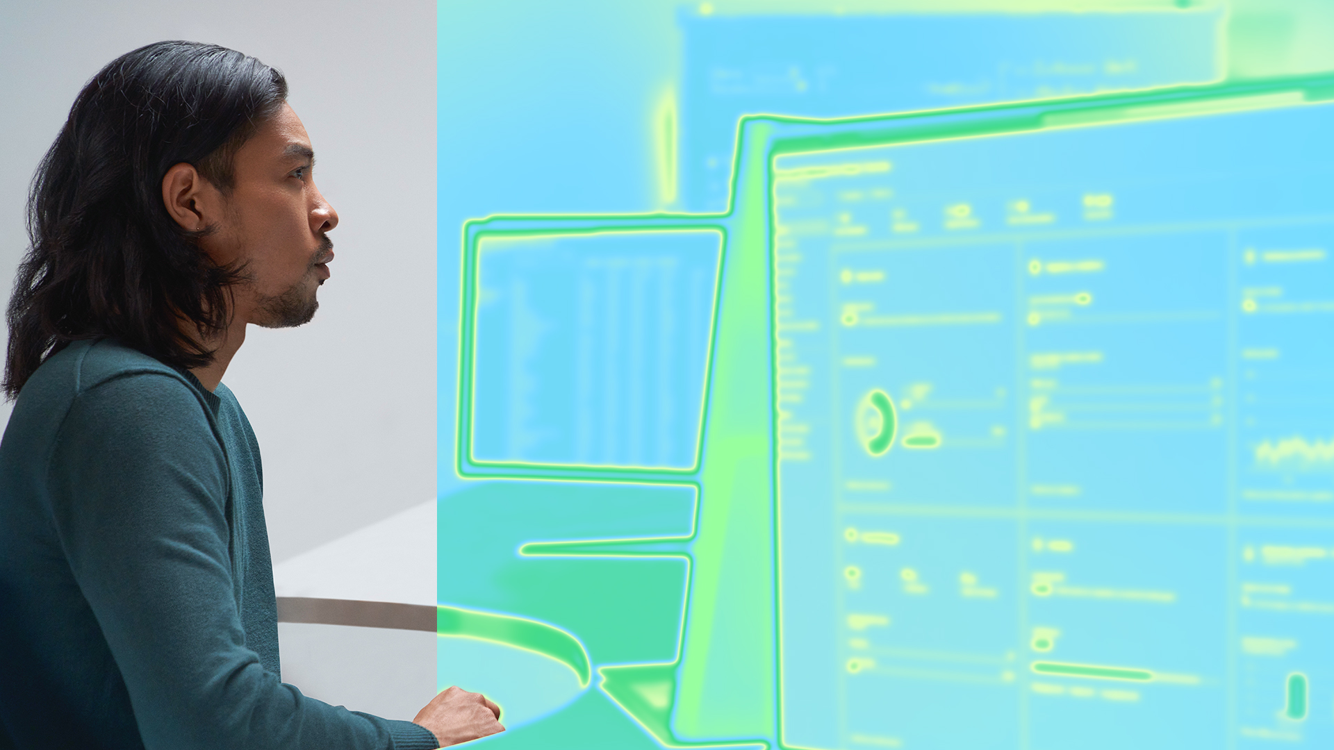 A security practitioner sits in front of a computer screen