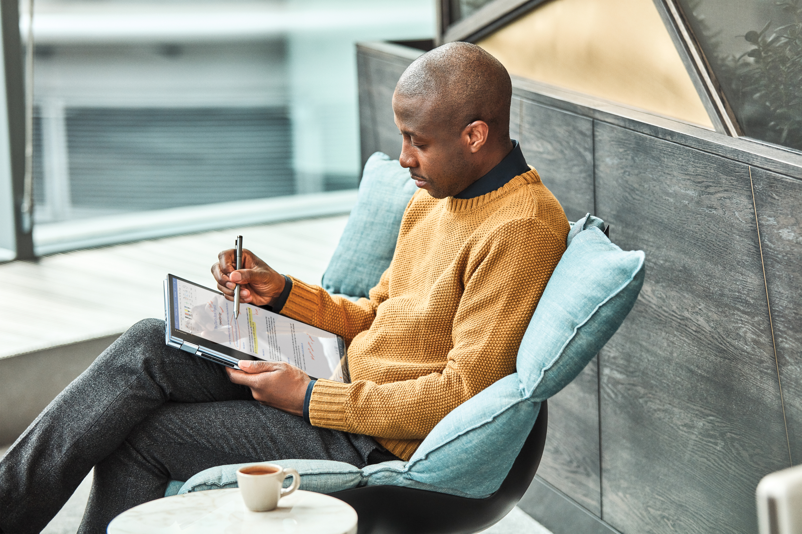 Man sitting alone looking at a tablet