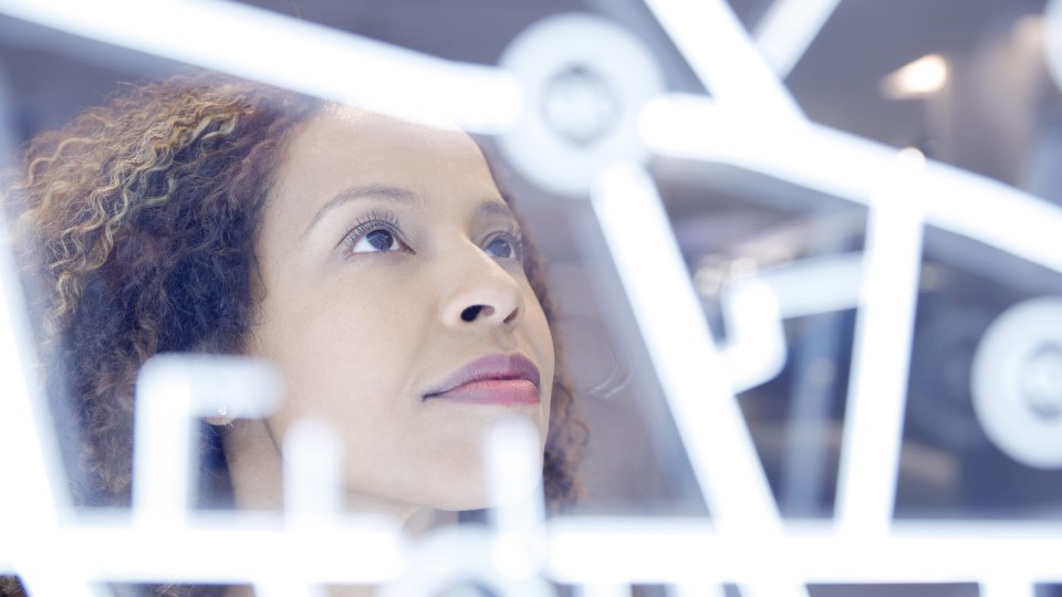 A woman looks at a digital interface