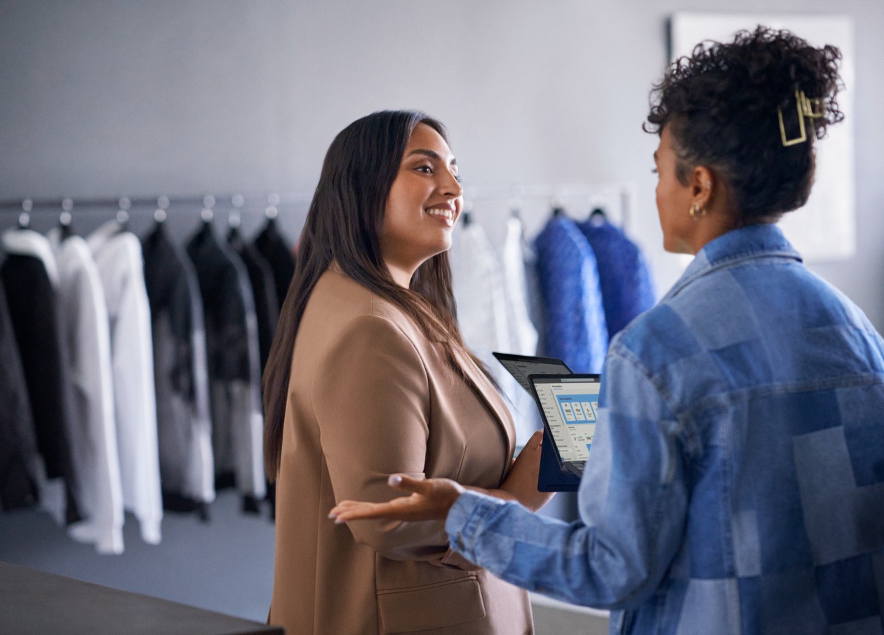 Azure solution powering retail business. Retail business operations manager reviewing real time data with employee