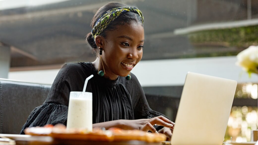A woman works at her PC in an open area in a Microsoft workspace.